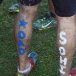 Body paint decorates the calves of Soldotna&rsquo;s Koby Vinson after the Division I boys race Saturday at the ASAA First National Bank Alaska Cross-country State Championships at Bartlett High School. (Photo by Joey Klecka/Peninsula Clarion)