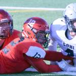 Riley Atwood, Tyrone McEnerney and Jersey Truesdell look to see that McEnerney had been awarded a two-point conversion in the second quarter at Ed Hollier Field in Kenai on Saturday, Sept. 30, 2017. (Photo by Jeff Helminiak/Peninsula Clarion)