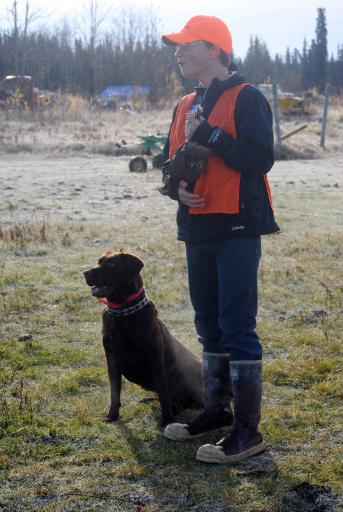 Mason St. Onge holds his recently shot chukar during Safari Club International&rsquo;s bird hunt on Saturday in Funny River. St. Onge had been moose and deer hunting, but Saturday was his first experience bird hunting. (Photo by Kat Sorensen/Peninsula Clarion)