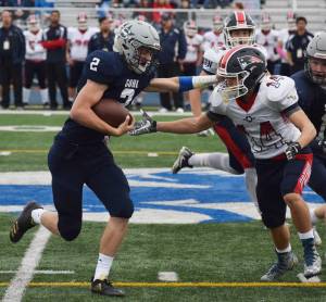 Soldotna running back Cody Quelland (2) stiff arms North Pole&rsquo;s Chris Berrellez Saturday at the ASAA First National Bank state football semifinals at Palmer High School. (Photo by Joey Klecka/Peninsula Clarion)
