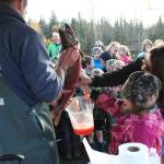 Jenny Gates and Tim Blackman, with the Alaska Department of Fish and Game, show students from lower Kenai Peninsula schools how to mix salmon eggs with salmon milt, or sperm, during an egg take demonstration Thursday, Oct. 5, 2017 at the Anchor River in Anchor Point, Alaska. (Photo by Megan Pacer/Homer News)