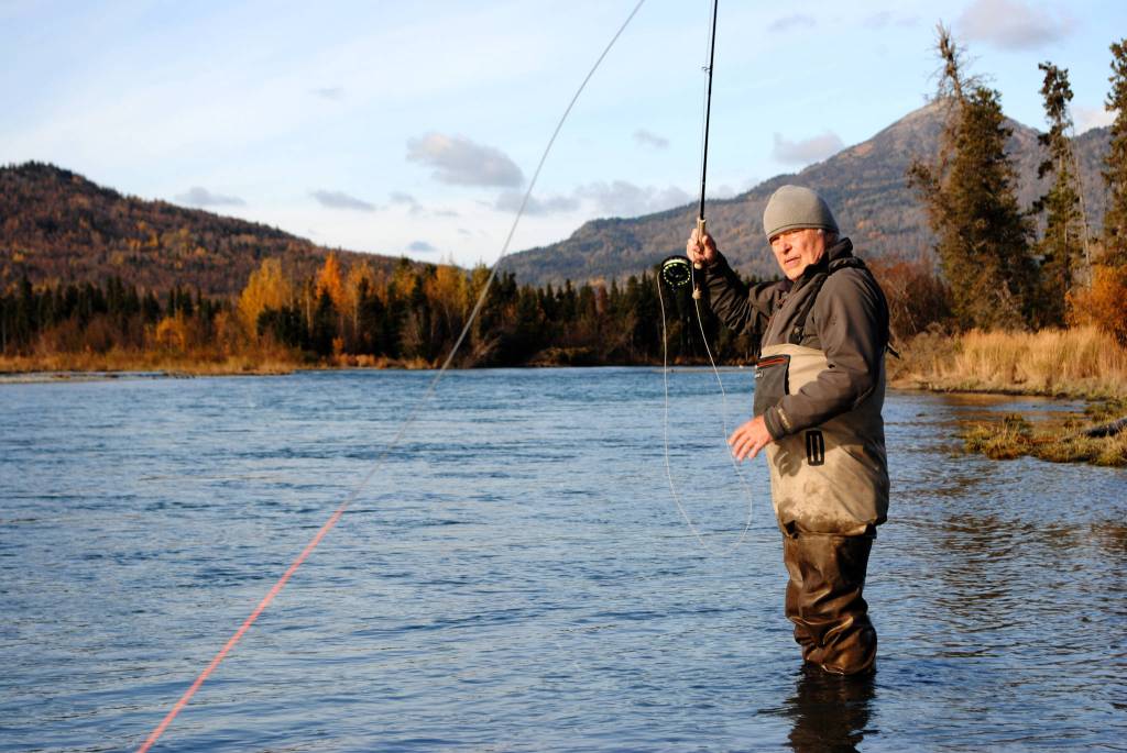 Mike Tuhy, owner and operator of the Tower Rock Lodge in Kenai, Alaska, casts for trout in the Upper River Kenai on Oct. 11, 2017. (Photo by Kat Sorensen/Peninsula Clarion)
