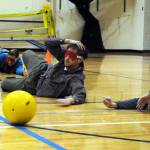 River City Academy teachers Annaleah Karron, Chris Kolishchak and Thomas Degray defend their goal in a Monday morning game of goalball at River City Academy in Soldotna, Alaska. Since the game is meant to be played by those with visual impairments, each team member had to wear blindfolds and listen for the ball, which is equipped with a jingling bell. (Photo by Kat Sorensen/Peninsula Clarion)