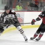Kenai River Brown Bears forward Alex Klekotka tries to make a play behind the net on Minnesota Magicians defenseman Matt Denman on Thursday, Oct. 26, 2017, at the Soldotna Regional Sports Complex. (Photo by Jeff Helminiak/Peninsula Clarion)