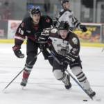 Kenai River Brown Bears forward Carter Wade drives the puck up the ice against Minnesota Magicians forward Bram Scheerer on Thursday, Oct. 26, 2017, at the Soldotna Regional Sports Complex. (Photo by Jeff Helminiak/Peninsula Clarion)