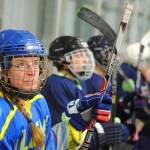Members of the Kenai River Queens watch their game and wait on a line shift on Thursday, Oct. 26, 2017 at Kenai Multipurpose Facility in Kenai, Alaska. (Photo by Kat Sorensen/Peninsula Clarion)