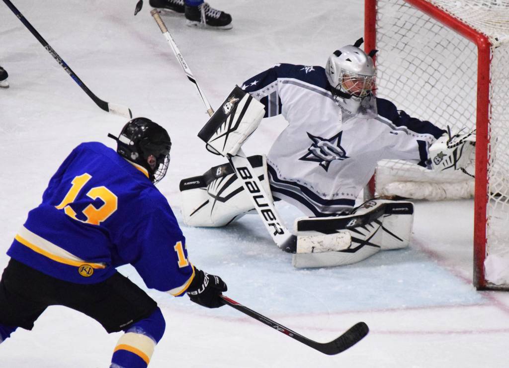 Soldotna goaltender Corbin Wirz reaches out too late to save a goal by Monroe Catholic&rsquo;s Antonio Szumigala Thursday at the Peninsula Ice Challenge at the Soldotna Regional Sports Complex. (Photo by Joey Klecka/Peninsula Clarion)