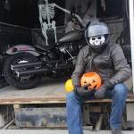 Biker Si of Peninsula Harley hands out sweets at Boys & Girls Club Trunk or Treat.
