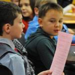Koebrien Lazenby, a second-grader at Kalifornsky Beach Elementary School, reads from his list of questions for a witness during the class&rsquo;s mock trial of &ldquo;Arthur T. Grinch&rdquo; based on the Dr. Seuss classic &ldquo;How the Grinch Stole Christmas&rdquo; on Thursday, Nov. 9, 2017 in Kenai, Alaska. The class has been studying civics and learning about the court process and put on a mock sentencing hearing, complete with witnesses and a jury composed of students&rsquo; parents and K-Beach Elementary Principal Nate Crabtree. (Photo by Elizabeth Earl/Peninsula Clarion)