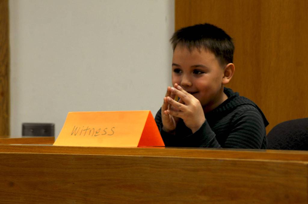 River Kruzick, a second-grader at Kalifornsky Beach Elementary School, prepares to answer a question during his testimony as &ldquo;Arthur T. Grinch&rdquo; during the class&rsquo;s mock trial based on Dr. Seuss&rsquo;s classic &ldquo;How the Grinch Stole Christmas&rdquo; on Thursday, Nov. 9, 2017 in Kenai, Alaska. The class has been studying civics and learning about the court process and put on a mock sentencing hearing, complete with witnesses and a jury composed of students&rsquo; parents and K-Beach Elementary Principal Nate Crabtree. (Photo by Elizabeth Earl/Peninsula Clarion)