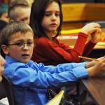 James Jensen, a second-grader at Kalifornsky Beach Elementary School, makes a face as one of his co-attorneys in the defense of &ldquo;Arthur T. Grinch&rdquo; asks a question during the class&rsquo;s mock trial based on Dr. Seuss&rsquo;s classic &ldquo;How the Grinch Stole Christmas&rdquo; on Thursday, Nov. 9, 2017 in Kenai, Alaska. The class has been studying civics and learning about the court process and put on a mock sentencing hearing, complete with witnesses and a jury composed of students&rsquo; parents and K-Beach Elementary Principal Nate Crabtree. (Photo by Elizabeth Earl/Peninsula Clarion)