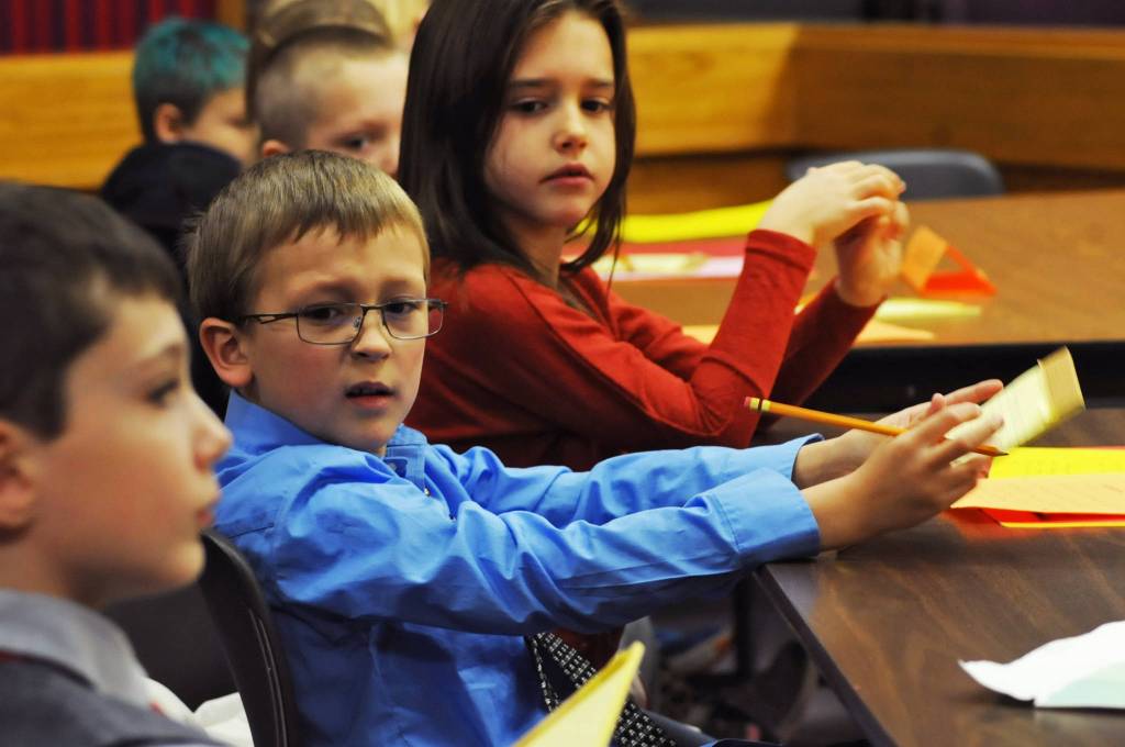 James Jensen, a second-grader at Kalifornsky Beach Elementary School, makes a face as one of his co-attorneys in the defense of &ldquo;Arthur T. Grinch&rdquo; asks a question during the class&rsquo;s mock trial based on Dr. Seuss&rsquo;s classic &ldquo;How the Grinch Stole Christmas&rdquo; on Thursday, Nov. 9, 2017 in Kenai, Alaska. The class has been studying civics and learning about the court process and put on a mock sentencing hearing, complete with witnesses and a jury composed of students&rsquo; parents and K-Beach Elementary Principal Nate Crabtree. (Photo by Elizabeth Earl/Peninsula Clarion)