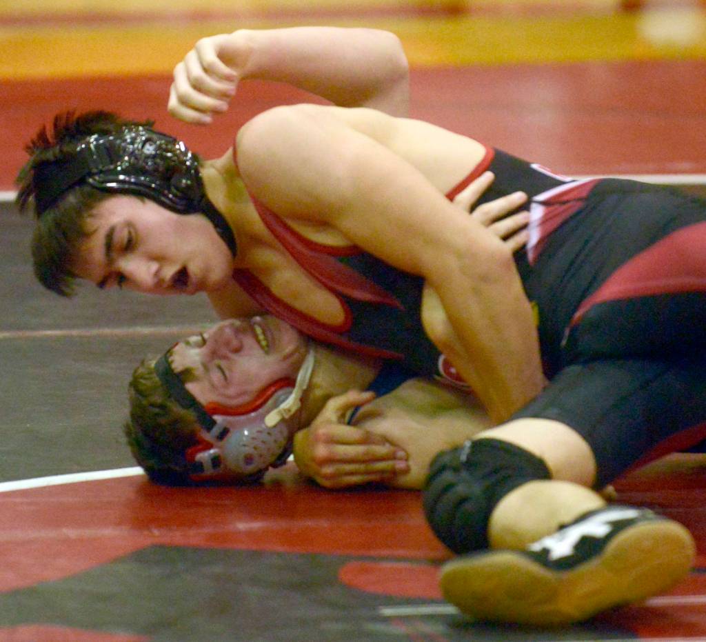 Kenai Central&rsquo;s Brandon Kroto prepares to pin Soldotna&rsquo;s Aiden Willets at 145 pounds Thusday, Nov. 9, 2017, at Kenai Central High School. (Photo by Jeff Helminiak/Peninsula Clarion)