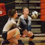 Soldotna junior Kalyn McGillivray (right) and senior Ella Stenga both go for a dig Friday against West Valley at the Class 4A state volleyball tournament at West High School. (Photo by Joey Klecka/Peninsula Clarion)