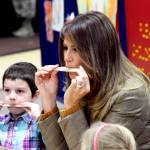 First lady Melania Trump plays a harmonica she made out of household items at Joint Base Elmendorf-Richardson, Alaska, on Friday, Nov. 10, 2017. Trump visited with children taking part in programs for the children of military members at the base in Anchorage, Alaska, before flying back to Washington, D.C. (AP Photo/Mark Thiessen)