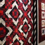 The Kachemak Bay Quilters spend a lot of their time creating quilts for victims of house fires, like the ones shown here during a First Friday exhibit Nov. 3 at the Homer Council on the Arts in Homer. (Photo by Megan Pacer/Homer News)