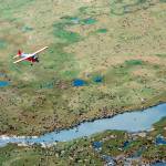 In this undated photo provided by the U.S. Fish and Wildlife Service, an airplane flies over caribou from the Porcupine Caribou Herd on the coastal plain of the Arctic National Wildlife Refuge in northeast Alaska. A showdown is looming in the nation&rsquo;s capital over whether to open America&rsquo;s largest wildlife refuge to oil drilling. A budget measure approved by the Republican-controlled Congress allows lawmakers to pursue legislation that would allow drilling on the coastal plain of the Arctic National Wildlife Refuge. The refuge takes up an area nearly the size of South Carolina in Alaska&rsquo;s northeast corner. (U.S. Fish and Wildlife Service via AP)