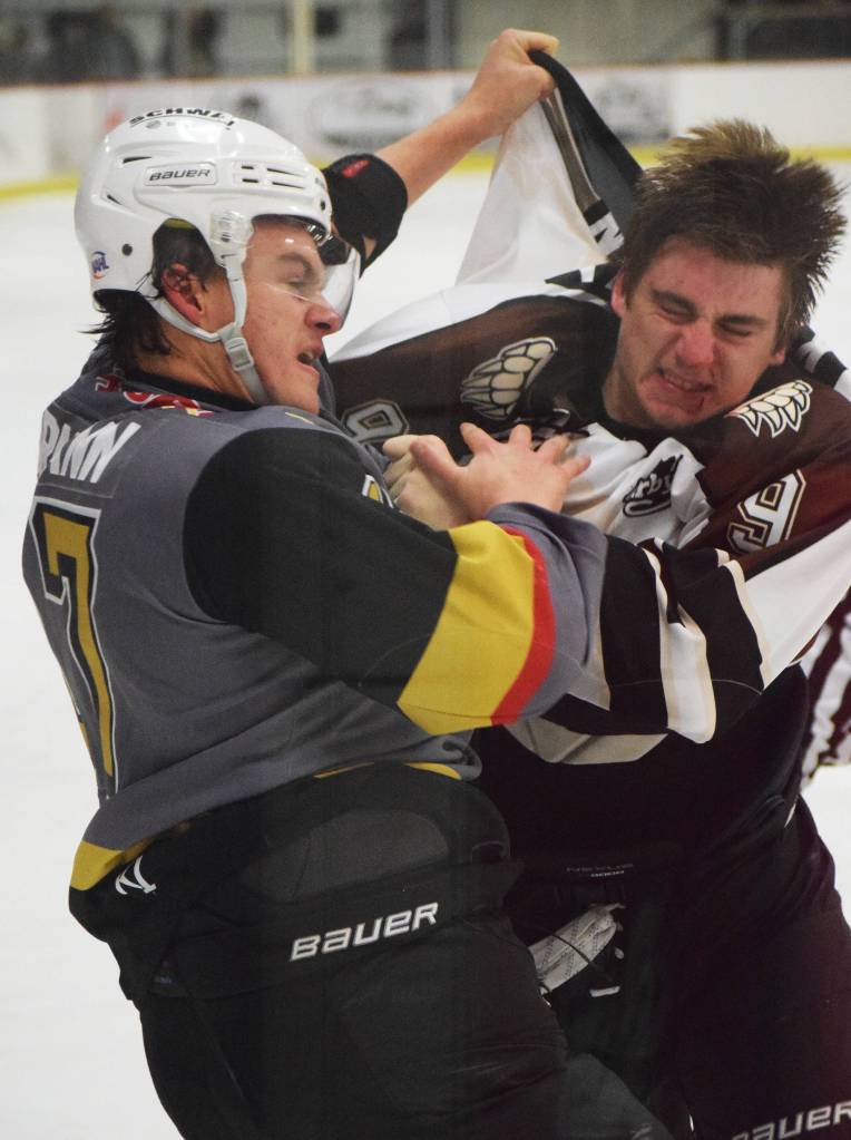Kenai River&rsquo;s Alex Klekotka (right) throws down the fisticuffs with Bismarck&rsquo;s Noah Bormann Friday night against the Bismarck Bobcats at the Soldotna Regional Sports Complex. (Photo by Joey Klecka/Peninsula Clarion)