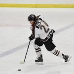 Kenai River&rsquo;s Zach Krajnik brings the puck up the ice Friday night against the Bismarck Bobcats at the Soldotna Regional Sports Complex. (Photo by Joey Klecka/Peninsula Clarion)