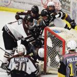 A scrum of Kenai River and Bismarck players gather around the Brown Bears net Friday night at the Soldotna Regional Sports Complex. (Photo by Joey Klecka/Peninsula Clarion)