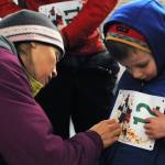 Carly Reimer pins a bib on her son Gus Reimer, 4, for the 1-mile run at the Turkey Trot run held at the Soldotna Regional Sports Complex on Thursday, Nov. 23, 2017 in Soldotna, Alaska. (Photo by Elizabeth Earl/Peninsula Clarion)