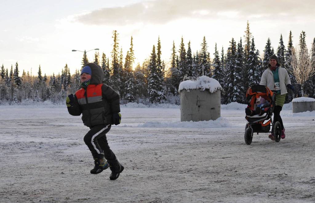 Nathan Nelson, 4, makes a final sprint to the finish of the 1-mile Turkey Trot race at the Soldotna Regional Sports Complex on Thursday, Nov. 23, 2017 in Soldotna, Alaska. The organizers of the event, which also included a 5K race, donated all the proceeds to Freedom House, a Soldotna-based nonprofit sober living home for women recovering from addiction. (Photo by Elizabeth Earl/Peninsula Clarion)