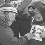 Carly Reimer pins a bib on her son Gus Reimer, 4, for the 1-mile run at the Turkey Trot run held at the Soldotna Regional Sports Complex on Thursday in Soldotna. (Photo by Elizabeth Earl/Peninsula Clarion)