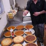 Kitchen manager Beau Jamison of the Duck Inn inspects pies ready to be served as part of the restaurant&rsquo;s traditional Thanksgiving meal in the kitchen of the Duck Inn on Kalifornsky Beach Road on Thursday, Nov. 23, 2017 near Soldotna, Alaska. (Ben Boettger/Peninsula Clarion)