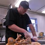 Kitchen manager Beau Jamison of the Duck Inn slices the breast meat of one of the twelve turkeys he prepared for the restuarant&rsquo;s Thanksgiving dinner at the Duck Inn on Kalifornsky Beach Road on Thursday, Nov. 23, 2017 near Soldotna, Alaska. This Thanksgiving &mdash; the twelfth for which that Jamison has prepared the Duck Inn&rsquo;s traditional meal, closes a year of hardship for Jamison &mdash; in August he recieved a clean diagnosis after struggling with lymphoma since October 2016, and it&rsquo;s his first year as a single father after his wife&rsquo;s death. (Ben Boettger/Peninsula Clarion)