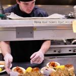 Duck Inn cook Jon DeMilta lays out two orders of traditional Thanksgiving fare &mdash; turkey, mashed potatoes, corn-on-the cob, stuffing, rolls, and yams &mdash; at the Duck Inn on Kalifornsky Beach Road on Thursday, Nov. 23. 2017 in Soldotna, Alaska. (Ben Boettger/Peninsula Clarion)