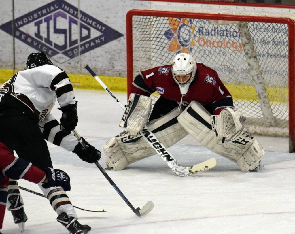 Fairbanks Ice Dogs goalie Logan Neaton prepares to stop Kenai River Brown Bears forward Luke Posner to preserve the shutout Friday, Nov. 24, 2017, at the Soldotna Regional Sports Complex. (Photo by Jeff Helminiak/Peninsula Clarion)