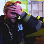Kenai River Brown Bears player Gil Garcia wipes away the sweat after removing his mask during a tour and training demonstration at the Kenai Emergency Operations Center on the Kenai Municipal Airport on Tuesday, Nov. 28, 2017 in Kenai, Alaska. Kenai Fire Department firefighters walked the Brown Bears players through some of the training and tools firefighters use to give them an idea of what a career in fire response is like. (Photo by Elizabeth Earl/Peninsula Clarion)