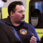 Kenai Fire Marshal Tommy Carver talks to the Kenai River Brown Bears hockey team players during a tour and training demonstratoin at the Kenai Emergency Operations Center on the Kenai Municipal Airport on Tuesday, Nov. 28, 2017 in Kenai, Alaska. Kenai Fire Department firefighters walked the Brown Bears players through some of the training and tools firefighters use to give them an idea of what a career in fire response is like. (Photo by Elizabeth Earl/Peninsula Clarion)