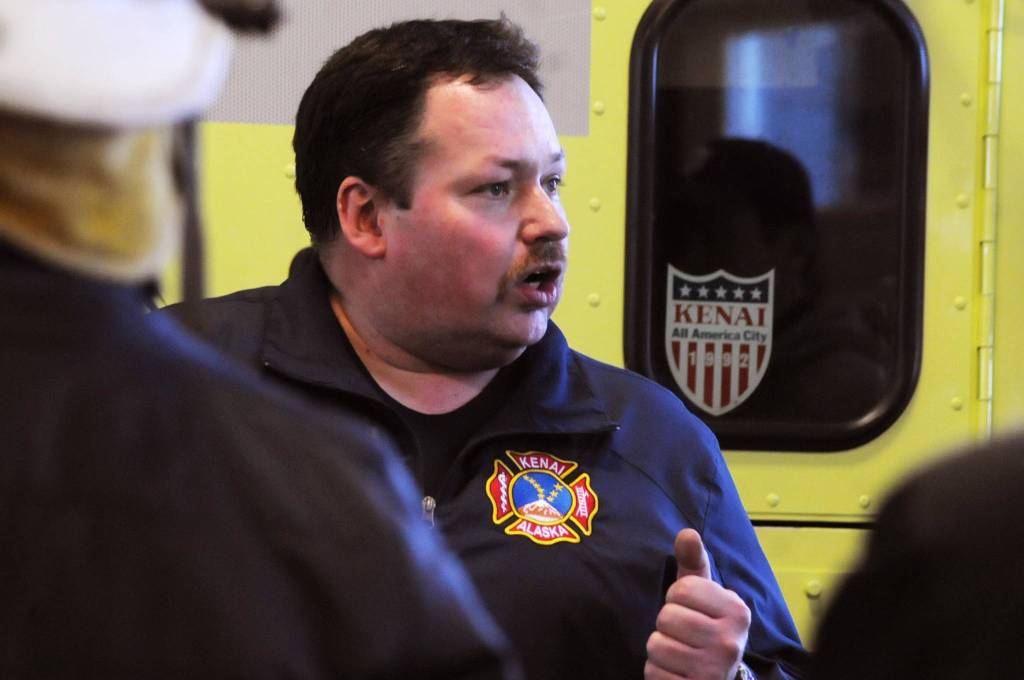 Kenai Fire Marshal Tommy Carver talks to the Kenai River Brown Bears hockey team players during a tour and training demonstratoin at the Kenai Emergency Operations Center on the Kenai Municipal Airport on Tuesday, Nov. 28, 2017 in Kenai, Alaska. Kenai Fire Department firefighters walked the Brown Bears players through some of the training and tools firefighters use to give them an idea of what a career in fire response is like. (Photo by Elizabeth Earl/Peninsula Clarion)