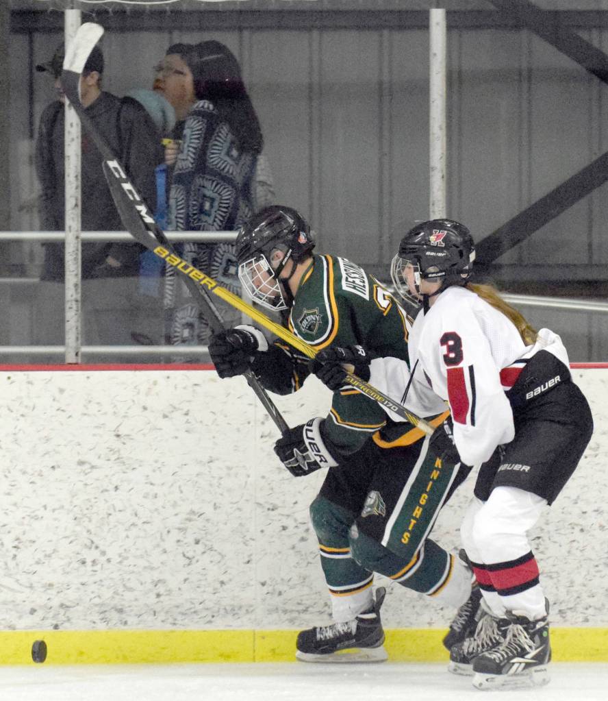 Colony&rsquo;s Jake Hessinger and Kenai Central&rsquo;s Claire Bryant battle for the puck along the boards Thursday, Nov. 30, 2017, at the Kenai Multi-Purpose Facility. (Photo by Jeff Helminiak/Peninsula Clarion)