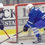 Palmer&rsquo;s Zach Nelius keeps Soldotna&rsquo;s Galen Brantley III from executing a wraparound on Palmer goalie Cale Winder on Thursday, Nov. 30, 2017, at the Soldotna Regional Sports Complex. (Photo by Jeff Helminiak/Peninsula Clarion)