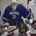 Palmer goaltender TJ O&rsquo;Rourke and Kenai Central&rsquo;s Matt Hagel (bottom) look for the puck Friday at the Kenai Multipurpose Facility. (Photo by Joey Klecka/Peninsula Clarion)