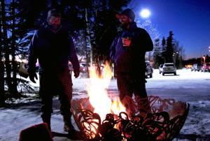 Kenai Watershed Forum water quality specialist Branden Bornemann (right) talks to a visitor during the Kenai Watershed Forum&rsquo;s holiday open house Wednesday, Dec. 7, 2017 in Soldotna, Alaska. The nonprofit held a community open house at its headquarters behind Soldotna Creek Park on Wednesday night to celebrate the events of the past year. (Photo by Ben Boettger/Peninsula Clarion)