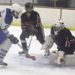 Kenai Cental goalie Josh Tree kicks away a Noah Keil shot during a 6-5 win over the Moose in the first round of the Big Lake Lions Christmas Classic on Thursday, Dec. 7, 2017, at the Big Lake Recreation Center. (Photo by Jeremiah Bartz/Frontiersman.com)