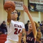 Kenai Central senior Lexy Carrasco (left) rolls in a layup ahead of Eielson&rsquo;s Robin Baker, Thursday night at the Craig Jung Kenai River Challenge at Kenai Central. (Photo by Joey Klecka/Peninsula Clarion)