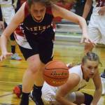 Eielson senior Dakota Martin chases after a ball with Kenai Central sophomore Damaris Severson (right) behind Thursday night at the Craig Jung Kenai River Challenge at Kenai Central. (Photo by Joey Klecka/Peninsula Clarion)