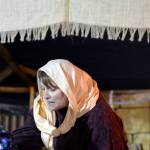 Brittany Liles operates a grain shop during Bethlehem Revisited at the College Heights Baptist Church in Soldotna on Saturday night. The event invites guests to explore the streets of Bethlehem as Mary and Joseph did the night of Jesus Christ&rsquo;s birth. The free event continues to Monday night and is open from 5 p.m. to 8 p.m., with a nativity reenactment at 5:30, 6:30 and 7:30 p.m. each night. (Photo by Kat Sorensen/Peninsula Clarion)