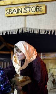 Brittany Liles operates a grain shop during Bethlehem Revisited at the College Heights Baptist Church in Soldotna on Saturday night. The event invites guests to explore the streets of Bethlehem as Mary and Joseph did the night of Jesus Christ&rsquo;s birth. The free event continues to Monday night and is open from 5 p.m. to 8 p.m., with a nativity reenactment at 5:30, 6:30 and 7:30 p.m. each night. (Photo by Kat Sorensen/Peninsula Clarion)