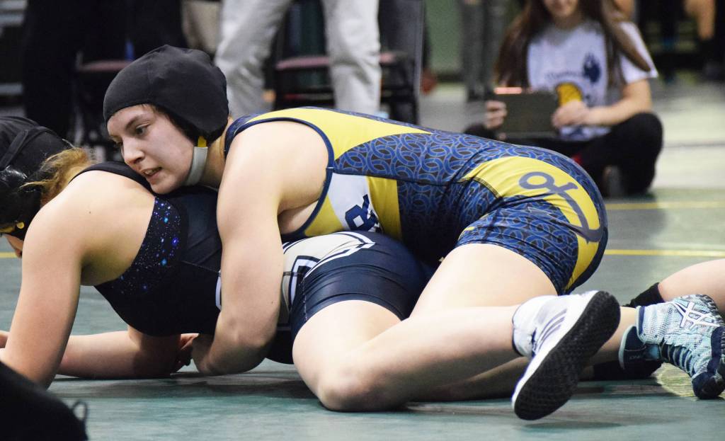 Homer&rsquo;s McKenzie Cook holds down Madison Ellis of South Anchorage Saturday night at the Girls State Wrestling Championships at the Alaska Airlines Center in Anchorage. (Photo by Joey Klecka/Peninsula Clarion)