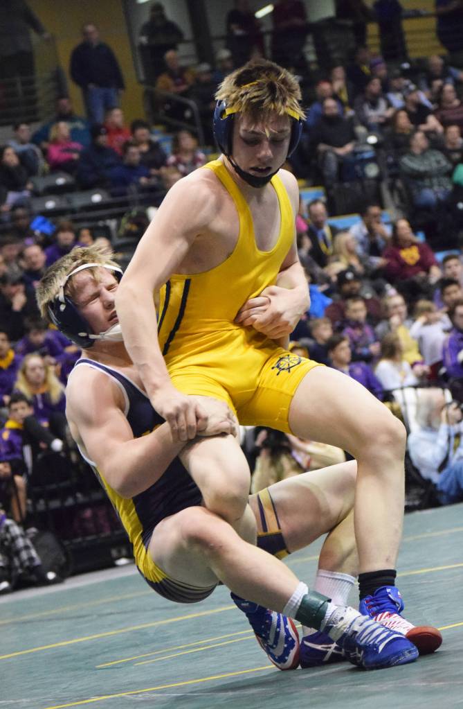 Monroe Catholic&rsquo;s Riley Rust (left) takes down Homer&rsquo;s Wayne Newman in the 126-pound final Saturday night at the Division II state wrestling championships at the Alaska Airlines Center in Anchorage. (Photo by Joey Klecka/Peninsula Clarion)