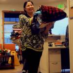 Roberta Turner of the Kenaitze Indian Tribe&rsquo;s Na&rsquo;ini Family and Social Services carries blankets donated by Girl Scouts Troop 254 to the center for its blanket drive. The girl scout troop, which includes 6th and 7th graders, collected blankets at Kalifornsky Beach Elementary School and Kenai Middle School to donate to the tribe. The blankets will be available for clients in need at the Na&rsquo;ini Family and Social Services building and some will be distributed at the Project Homeless Connect event in January 2018. (Photo by Elizabeth Earl/Peninsula Clarion)