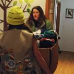 Michelle Ostrowski (right), the leader of the local Girl Scouts Troop 254, helps one of the scouts carry in a box of blankets the troop donated to the Kenaitze Indian Tribe&rsquo;s Na&rsquo;ini Family and Social Services for its blanket drive Tuesday, Dec. 19, 2017 in Kenai, Alaska. The girl scout troop, which includes 6th and 7th graders, collected blankets at Kalifornsky Beach Elementary School and Kenai Middle School to donate to the tribe. The blankets will be available for clients in need at the Na&rsquo;ini Family and Social Services building and some will be distributed at the Project Homeless Connect event in January 2018. (Photo by Elizabeth Earl/Peninsula Clarion)