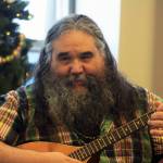 Local musician George Demientieff Holly sings and plays mandolin during a Dec. 21 winter solstice performance at Dena&rsquo;ina Wellness Center in downtown Kenai. (Photo by Erin Thompson/Peninsula Clarion)