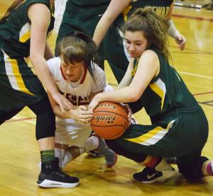 Kenai Central senior Kasey Paxton (left) wrestles for the ball with Seward sophomore Sophia Dow, Thursday night at Kenai Central High School. (Photo by Joey Klecka/Peninsula Clarion)