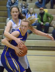 Photo by Joey Klecka/Peninsula Clarion Soldotna sophomore Danica Schmidt hounds Kodiak&rsquo;s Sydney Mutch for the ball in a Northern Lights Conference matchup Jan. 7, 2017, at the Soldotna Prep gymnasium.